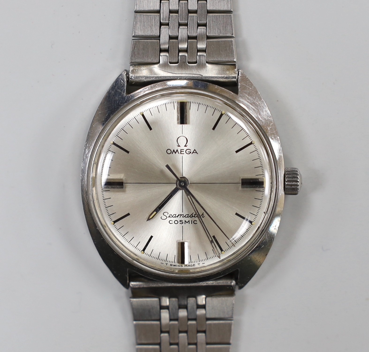 A gentleman's 1970's? stainless steel Omega Seamaster Cosmic manual wind wrist watch, on associated bracelet, case diameter 34mm.